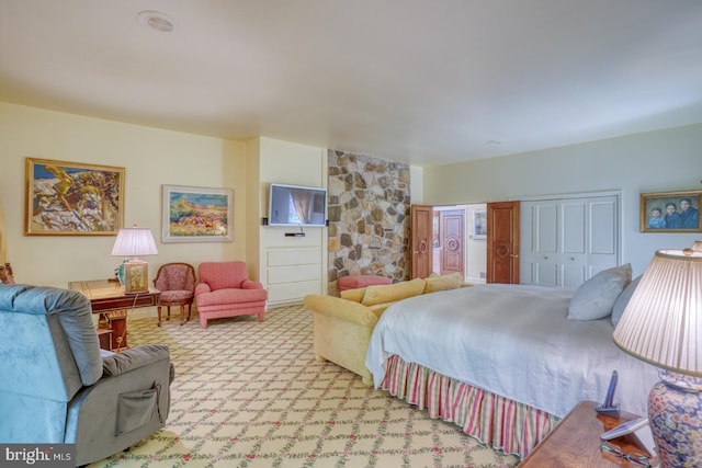 bedroom featuring light carpet and a closet