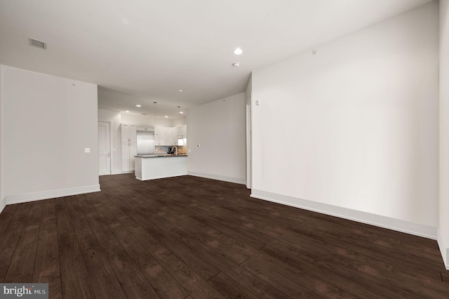 unfurnished living room featuring dark hardwood / wood-style floors