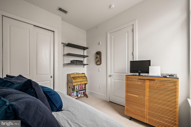 bedroom featuring carpet and a closet