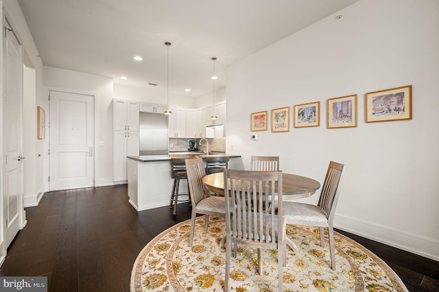 dining room featuring dark wood-type flooring and sink