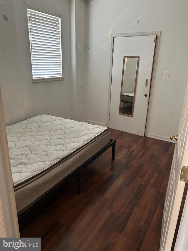 bedroom featuring dark hardwood / wood-style flooring