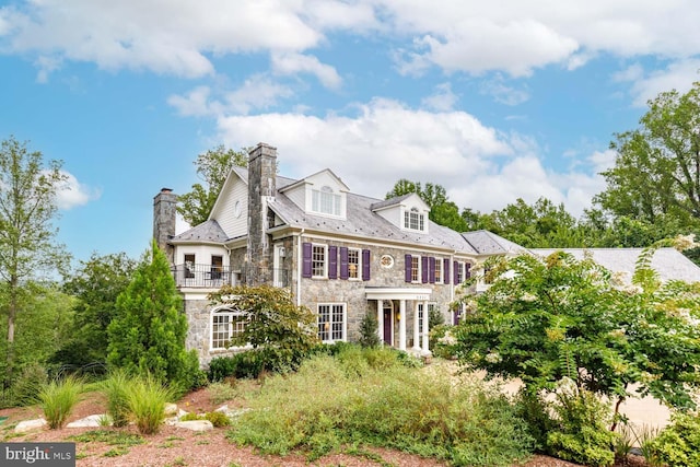 view of front of house featuring a balcony