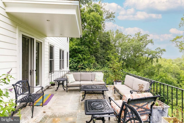 view of patio / terrace with an outdoor living space with a fire pit