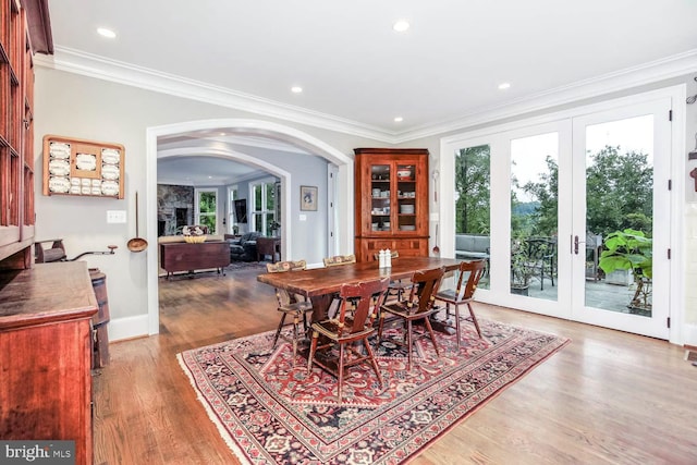 dining room featuring hardwood / wood-style floors, crown molding, and french doors