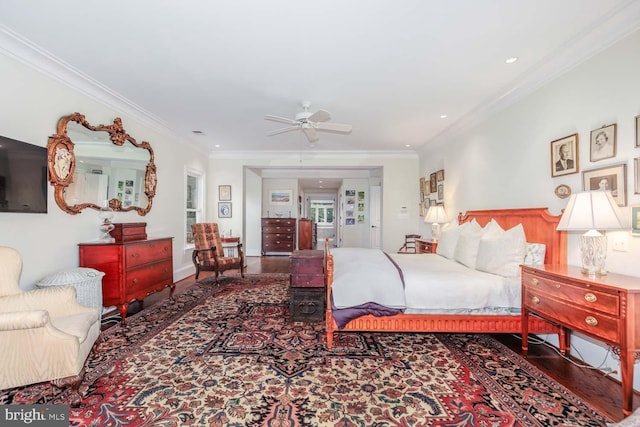 bedroom featuring crown molding, hardwood / wood-style flooring, and ceiling fan