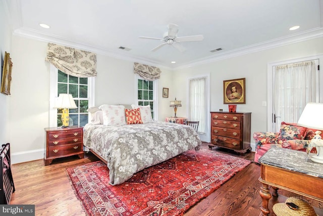 bedroom featuring crown molding, hardwood / wood-style flooring, and ceiling fan