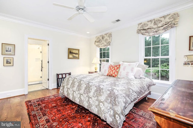 bedroom featuring ceiling fan, ornamental molding, multiple windows, and hardwood / wood-style floors