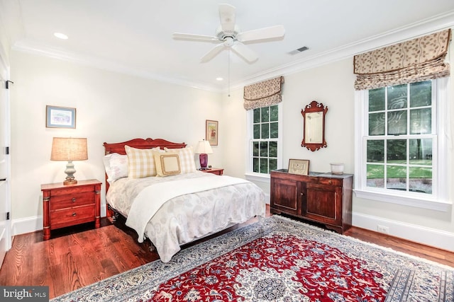 bedroom featuring ceiling fan, crown molding, multiple windows, and dark hardwood / wood-style flooring