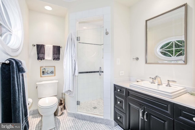 bathroom featuring vanity, toilet, and walk in shower