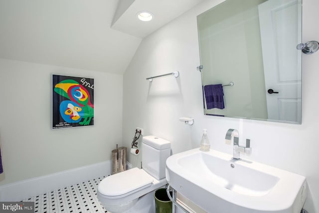 bathroom with vanity, toilet, and vaulted ceiling