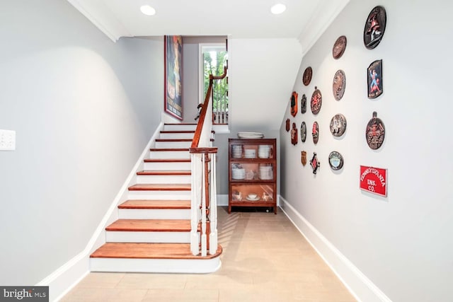 stairs featuring crown molding and tile patterned flooring