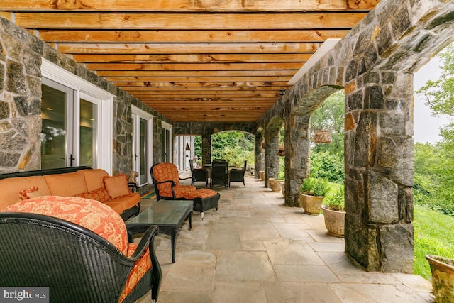 view of patio with an outdoor living space and a pergola