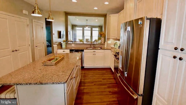 kitchen featuring light stone countertops, dark hardwood / wood-style floors, stainless steel appliances, and white cabinets