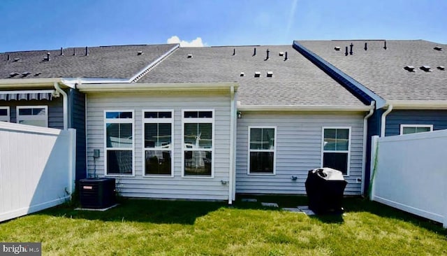 back of house featuring a yard and central AC unit