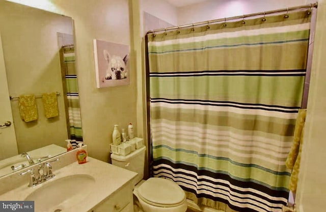 bathroom with vanity, toilet, and a shower with curtain