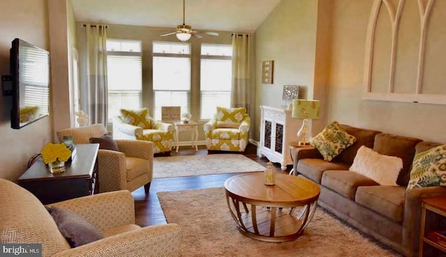 living room featuring ceiling fan, lofted ceiling, and dark hardwood / wood-style floors