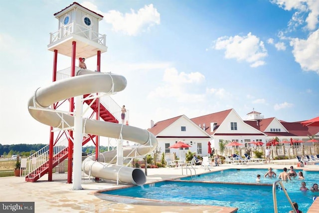 view of swimming pool featuring a patio and a water slide