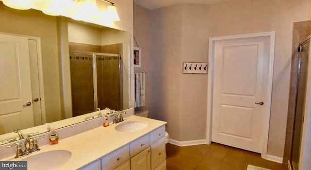 bathroom featuring walk in shower, vanity, and tile patterned floors