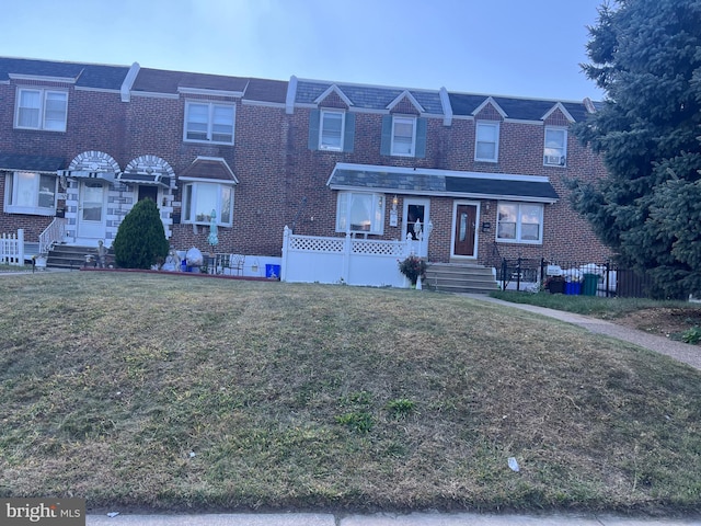 view of property featuring a front lawn