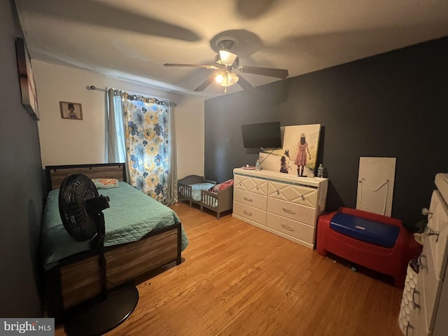 bedroom with light hardwood / wood-style flooring and ceiling fan