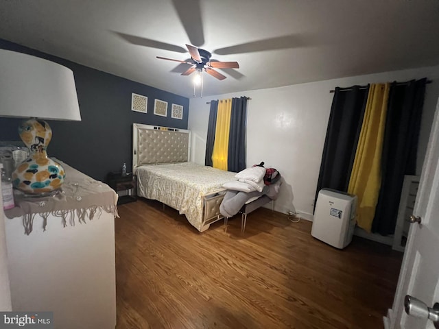 bedroom featuring ceiling fan and dark hardwood / wood-style flooring