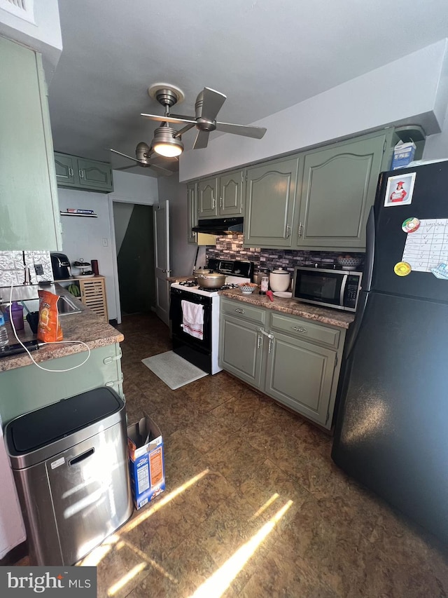 kitchen featuring tasteful backsplash, white electric range oven, black fridge, and ceiling fan