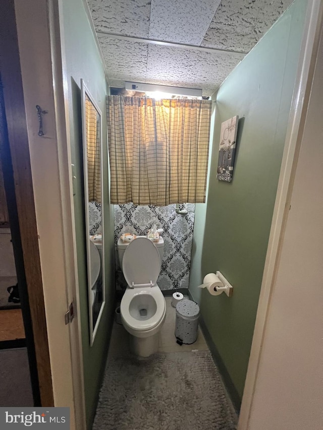 bathroom featuring tile patterned flooring and toilet