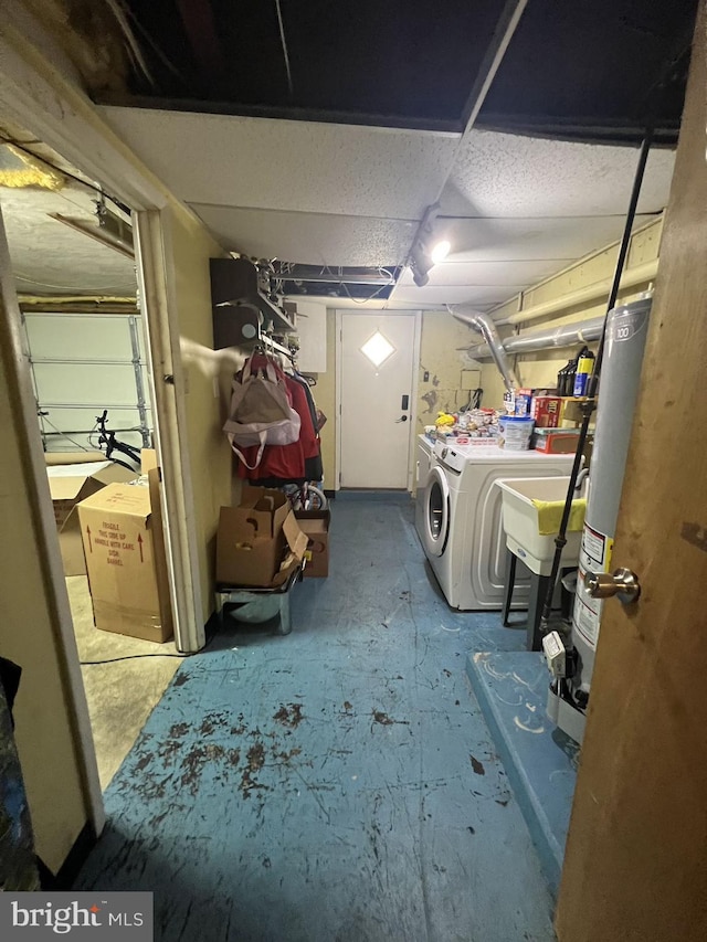 laundry room with gas water heater and washing machine and dryer