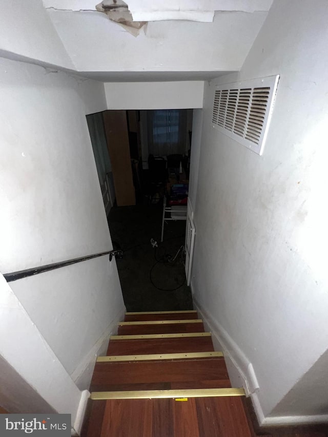 staircase featuring hardwood / wood-style flooring