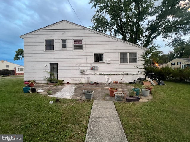 rear view of house featuring a lawn