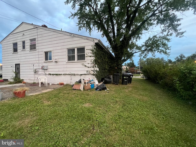 view of side of property with a yard and a patio area