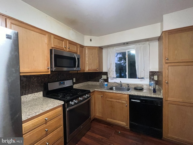 kitchen featuring stainless steel appliances, tasteful backsplash, dark wood-type flooring, and sink