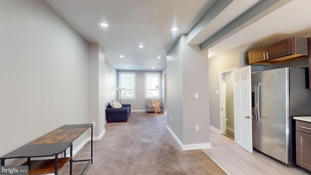 hallway with light colored carpet