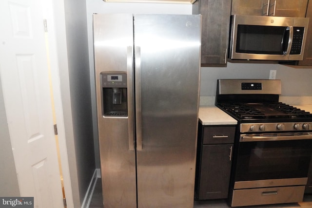 kitchen featuring dark brown cabinets and appliances with stainless steel finishes