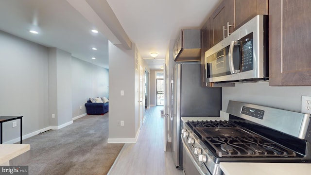 kitchen with stainless steel appliances and light hardwood / wood-style flooring