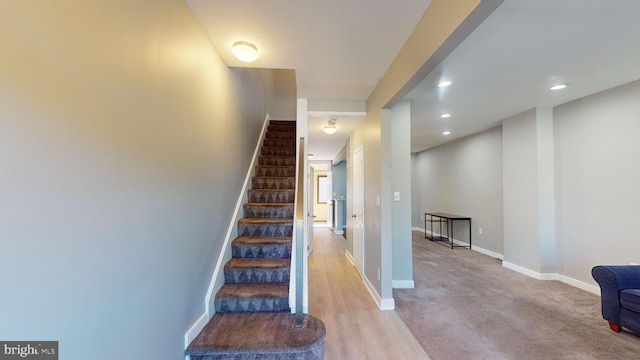 stairway with hardwood / wood-style flooring