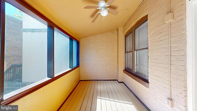 unfurnished sunroom featuring ceiling fan and lofted ceiling