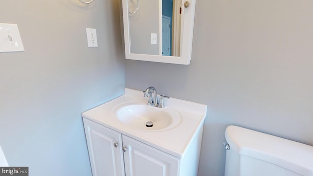 bathroom featuring toilet and vanity