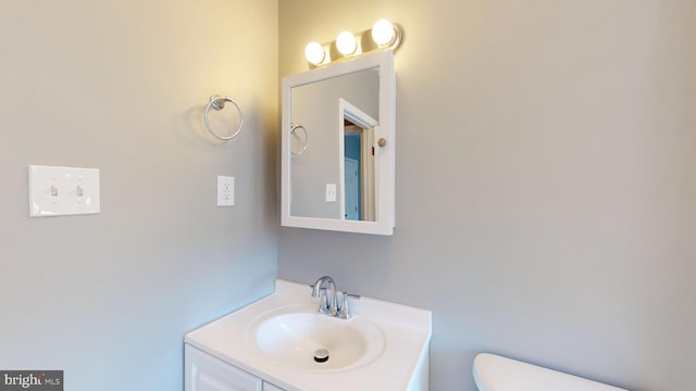 bathroom featuring vanity and toilet