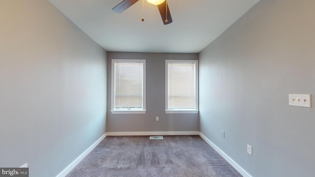 empty room with light colored carpet and ceiling fan