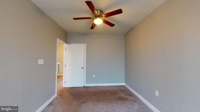 spare room with light colored carpet and ceiling fan