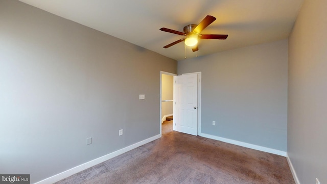 carpeted empty room with ceiling fan