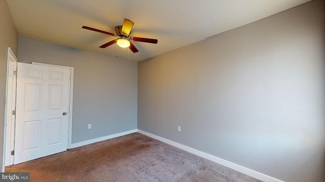 carpeted empty room featuring ceiling fan