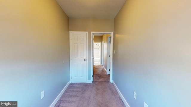 hall featuring light colored carpet