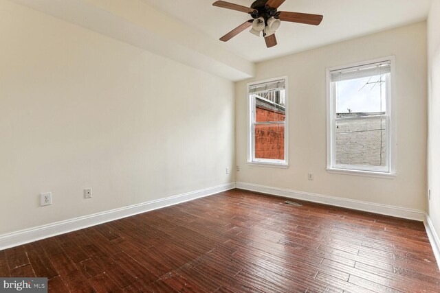 empty room featuring ceiling fan and dark wood-type flooring