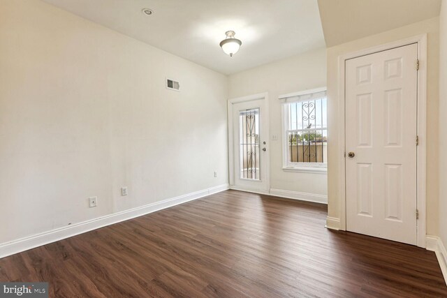 foyer entrance with dark wood-type flooring