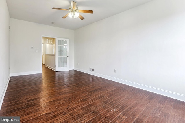 spare room with ceiling fan, dark hardwood / wood-style floors, and french doors