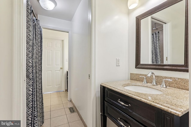 bathroom featuring tile patterned flooring and vanity