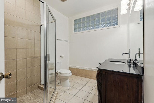 bathroom featuring tile patterned floors, an enclosed shower, vanity, and toilet