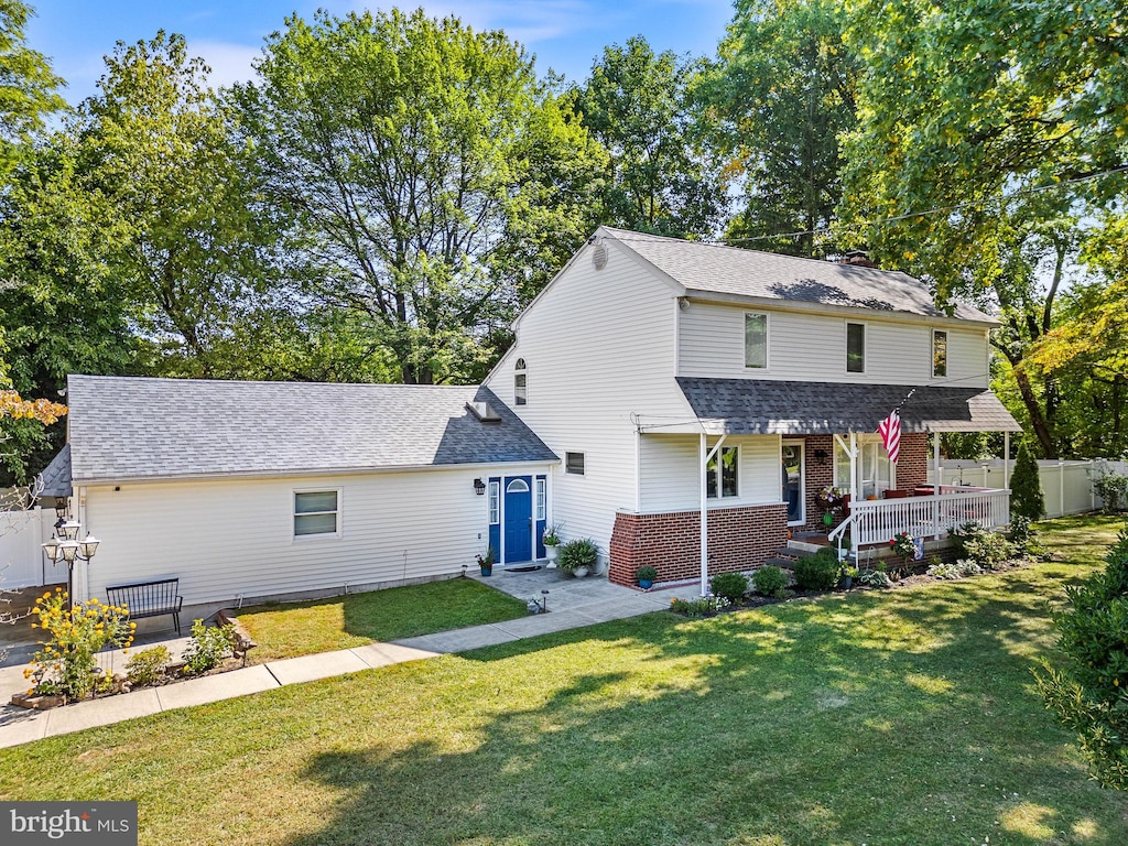 view of property featuring a front lawn